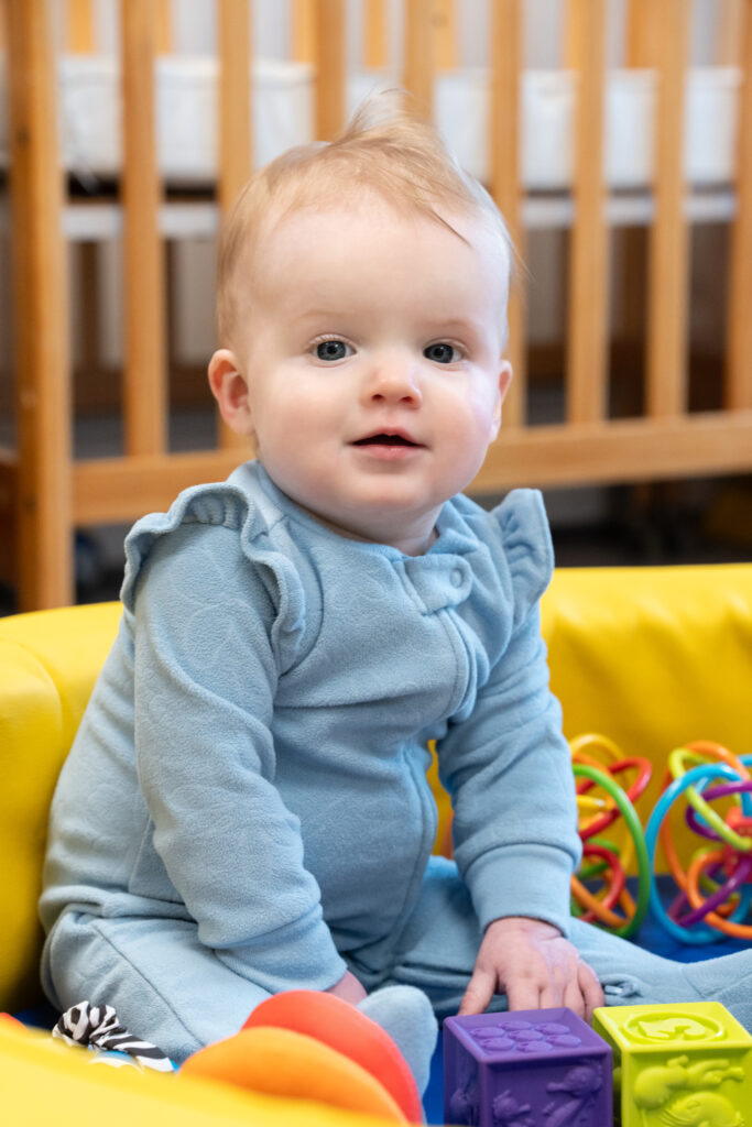 Infant playing inside the Infant Room at Duck Pond Day Care